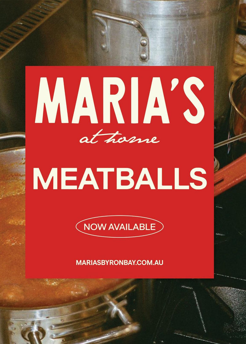 Stovetop with pot of meatballs and a red sign advertising 'Maria's Meatballs' with website URL.
