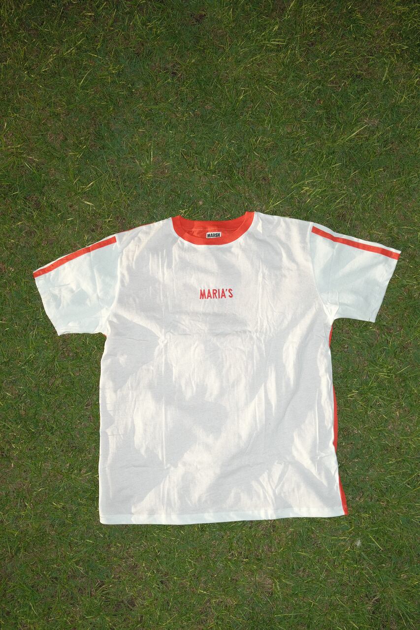 White MARIA’S Football Jersey on a grassy background