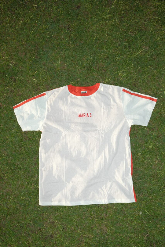 White MARIA’S Football Jersey on a grassy background