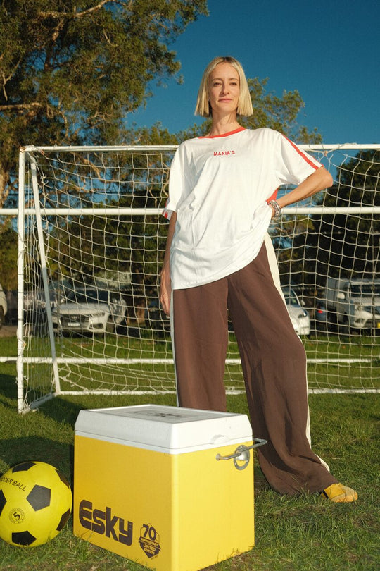 Person wearing MARIA’S Football sports Jersey jersey on a soccer field.